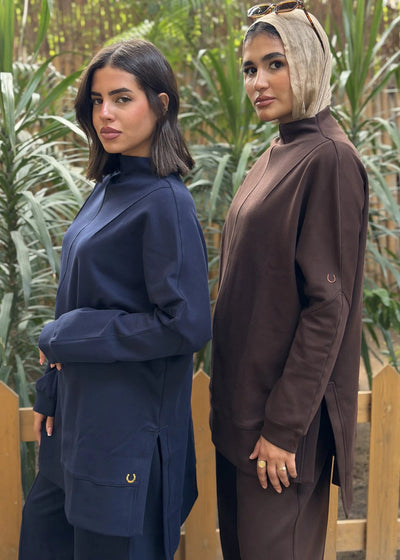 Two women standing outdoors with a natural background