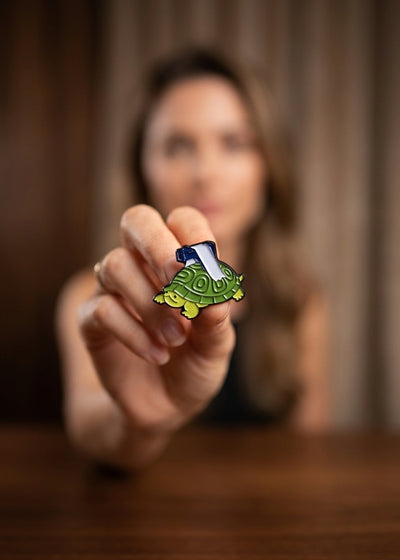 TURTLE WITH A GUN ENAMEL PIN